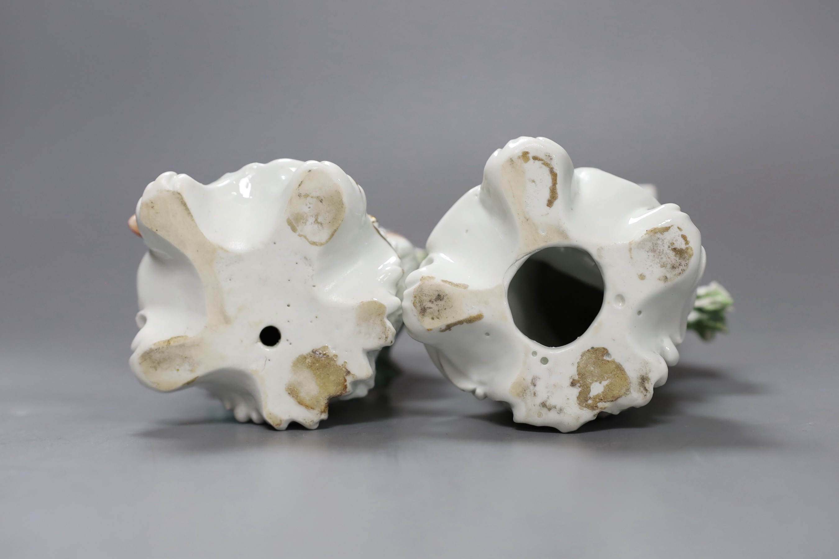 Two Derby sweetmeat figures, each seated and resting with an open rectangular basket on their knees, c.1760-65, patch marks, 20cm